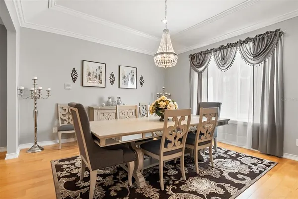a living room with furniture chandelier and a table