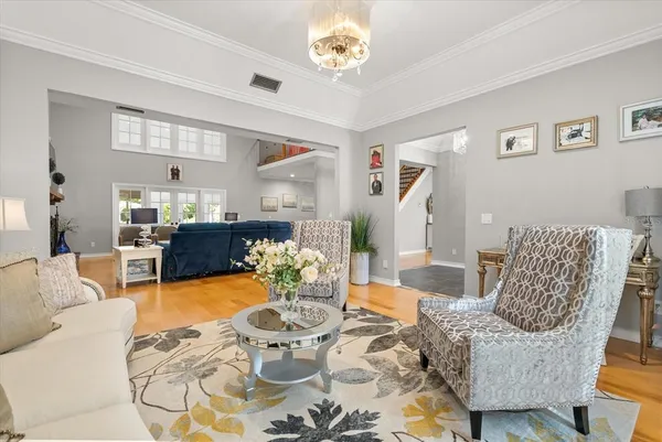 a kitchen with stainless steel appliances kitchen island granite countertop a dining table and chairs