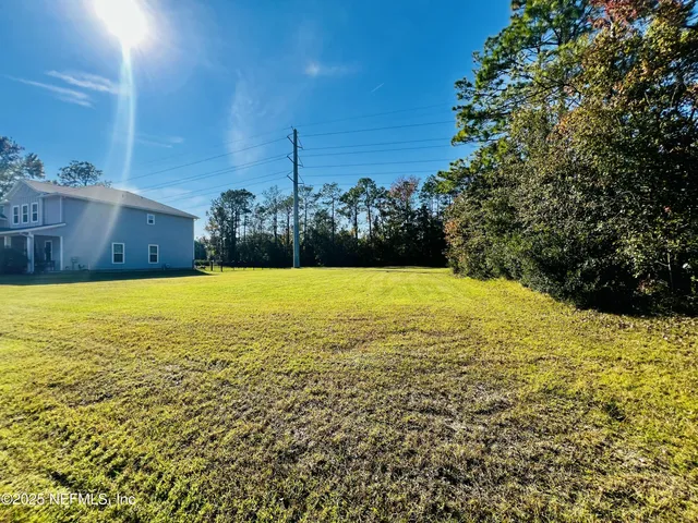 a view of a house with a yard and swimming pool
