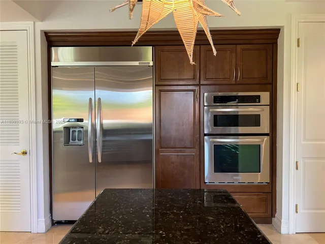 a kitchen with a refrigerator and a stove
