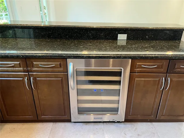 a kitchen with stainless steel appliances kitchen island granite countertop a refrigerator and a stove top oven