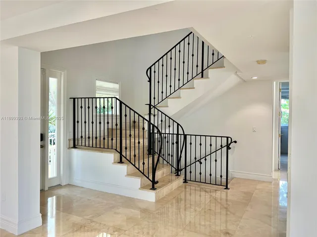 a bathroom with a granite countertop toilet sink and mirror