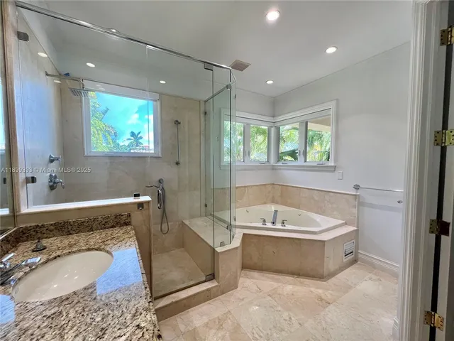 a bathroom with a bathtub and a shower