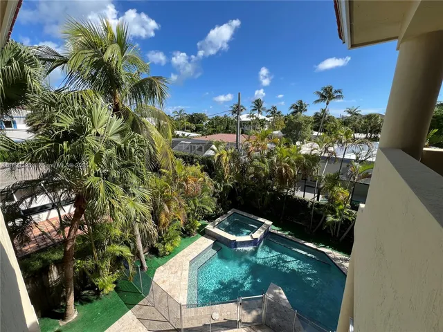 a view of backyard with swimming pool and outdoor seating