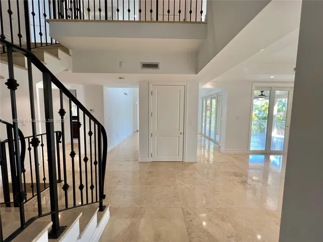 a view of an entryway with wooden floor