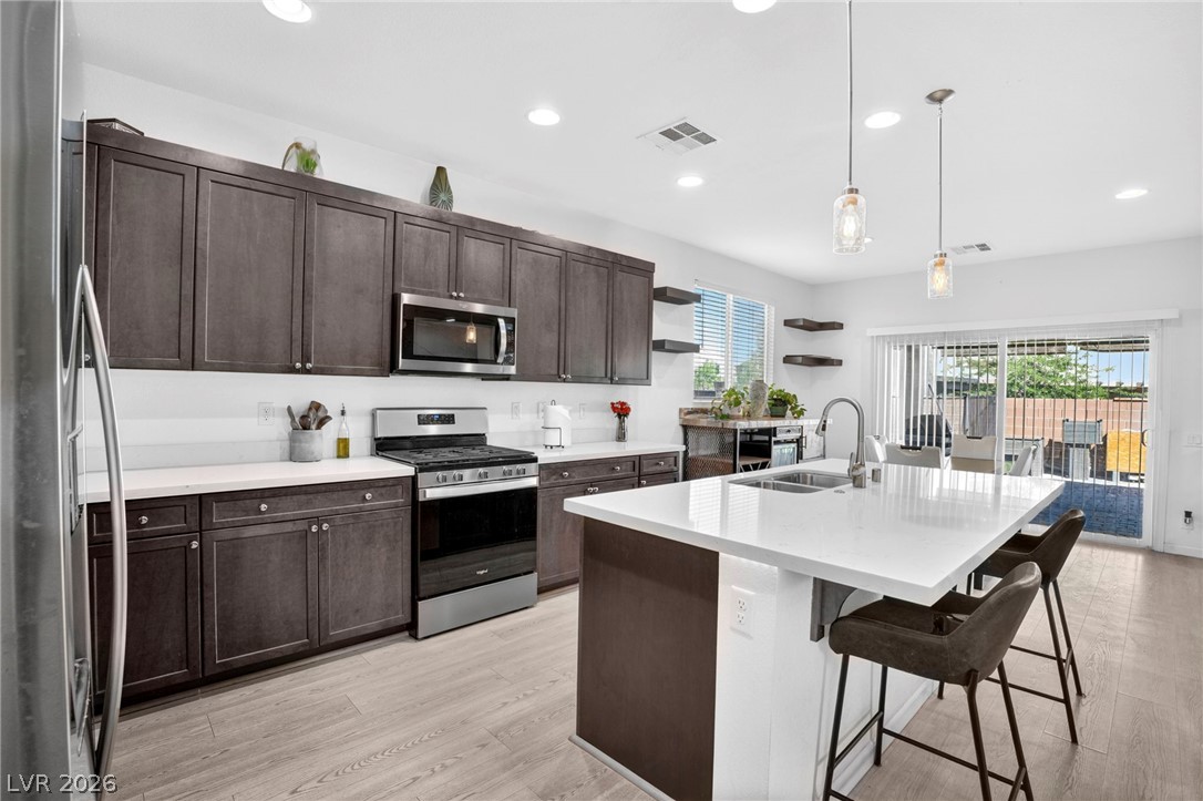 6281 Angora Peak Lane Las Vegas, NV 89115 - Photo 13 of 34 Culinary delights await in this modern kitchen with ample cabinetry and an inviting island.