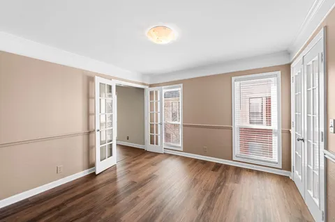 a view of an empty room with wooden floor