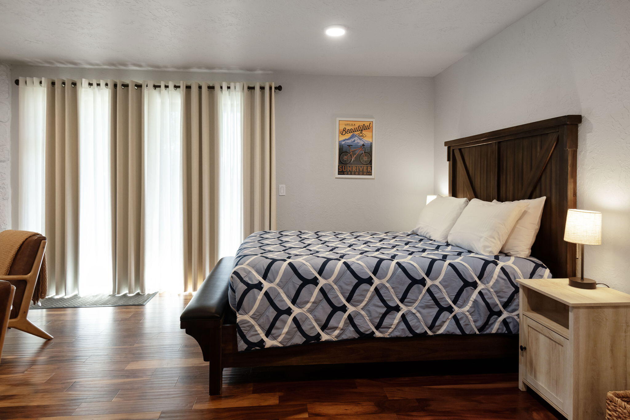 17654 Pinnacle Lane, Unit 16 Sunriver, OR 97707 - Photo 12 of 28 a bedroom with a bed and wooden floor