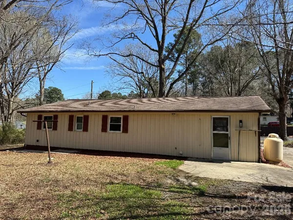 a house with trees in the background