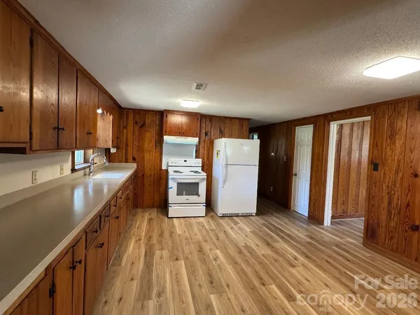 a kitchen with stainless steel appliances granite countertop a refrigerator sink and cabinets