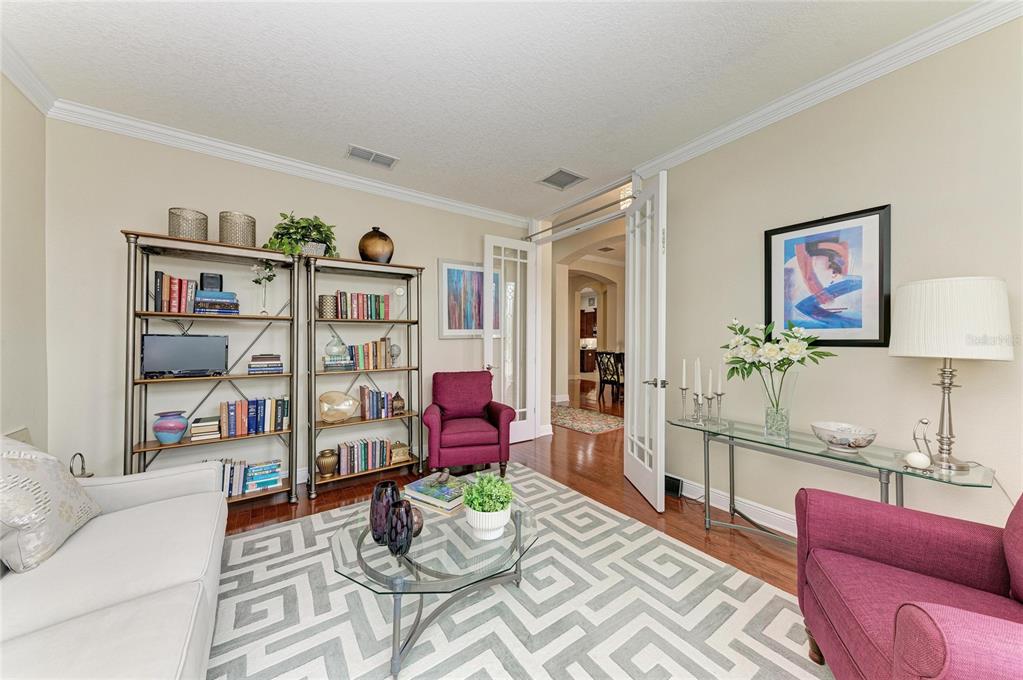 302 Cockle Shell Loop Apollo Beach, FL 33572 - Photo 10 of 75 a living room with furniture cabinets and a book shelf