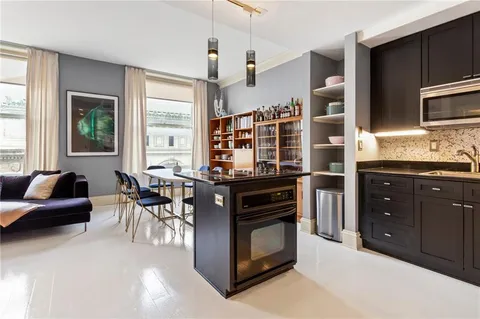a kitchen with stainless steel appliances granite countertop a stove and a refrigerator