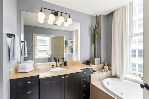 a bathroom with a sink vanity granite and a mirror