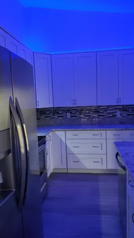 a view of a kitchen with wooden floor