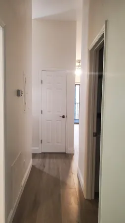 an empty room with wooden floor