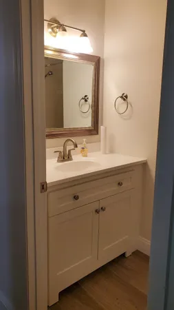 a bathroom with a double vanity sink and mirror