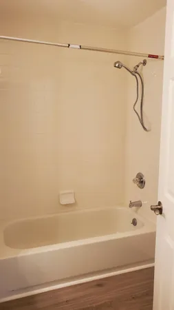 a bathroom with a shower and a bath tub
