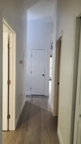 an empty room with closet and a bathroom