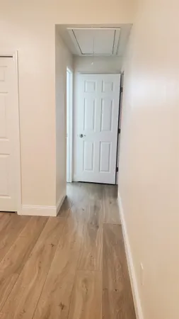 a view of room with wooden floor