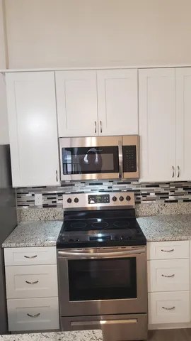 a stove top oven sitting inside of a kitchen