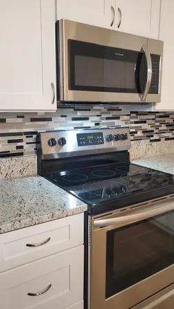 a stove top oven sitting inside of a kitchen
