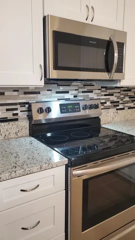 a stove top oven sitting inside of a kitchen