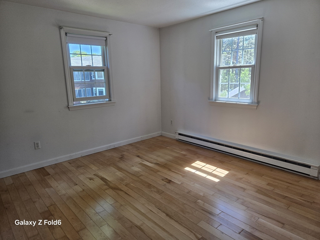 222 Buck Island Road, Unit 45 Yarmouth, MA 02673 - Photo 17 of 23 a view of empty room with wooden floor and fan