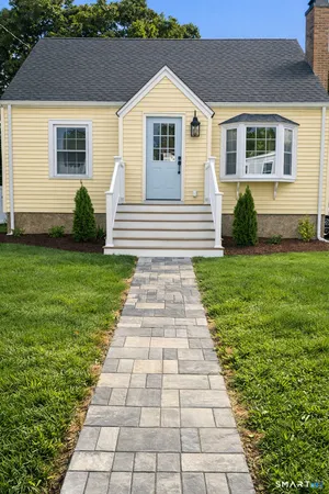 a front view of a house with a yard