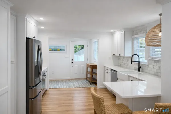 a kitchen with a sink refrigerator and window