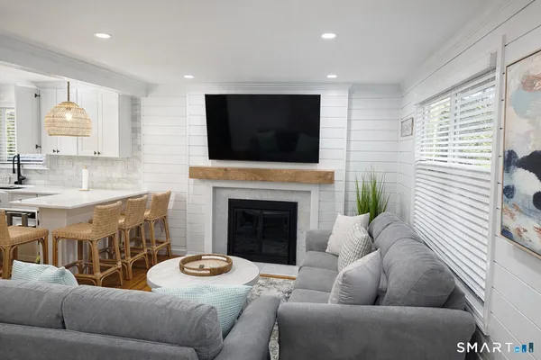 a living room with furniture and a fireplace