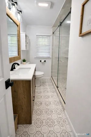 a bathroom with a sink toilet and shower