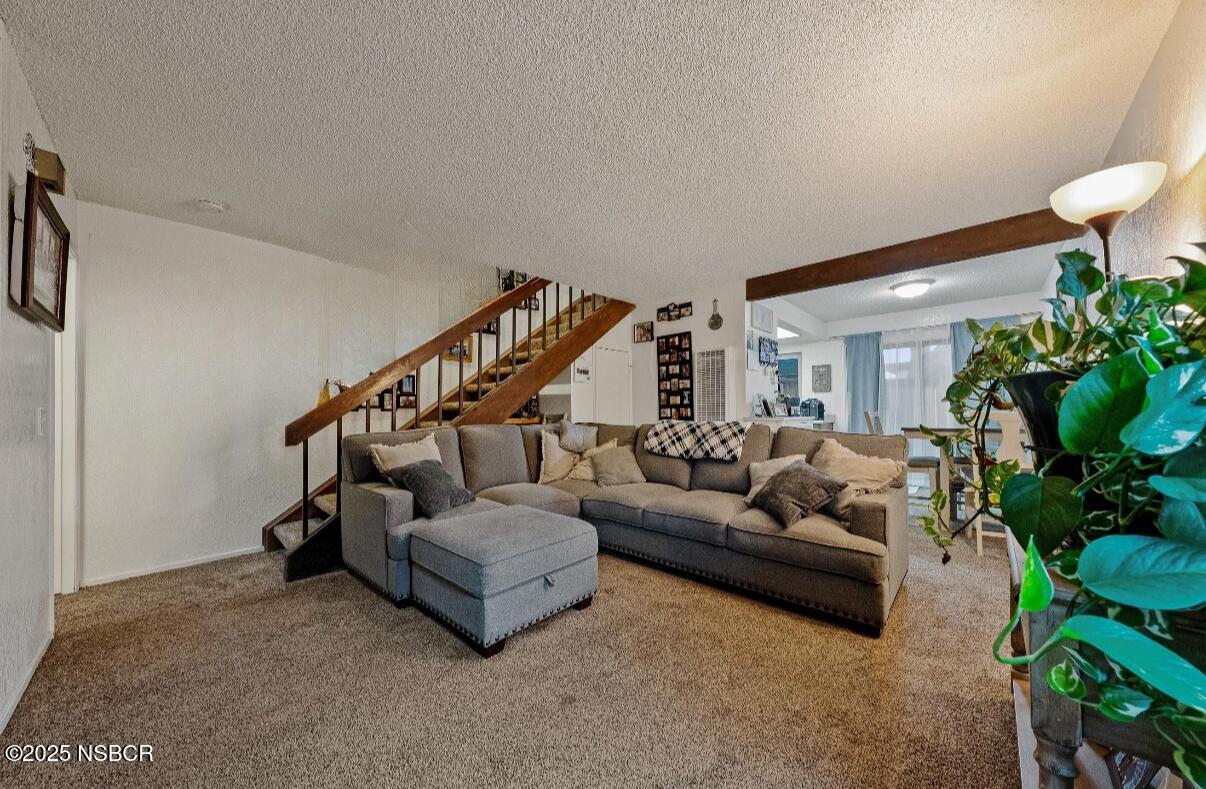 1210 East Walnut Avenue, Unit D Lompoc, CA 93436 - Photo 5 of 15 a living room with furniture and a potted plant