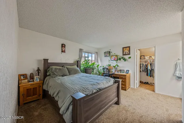 a bedroom with a bed and a view of kitchen
