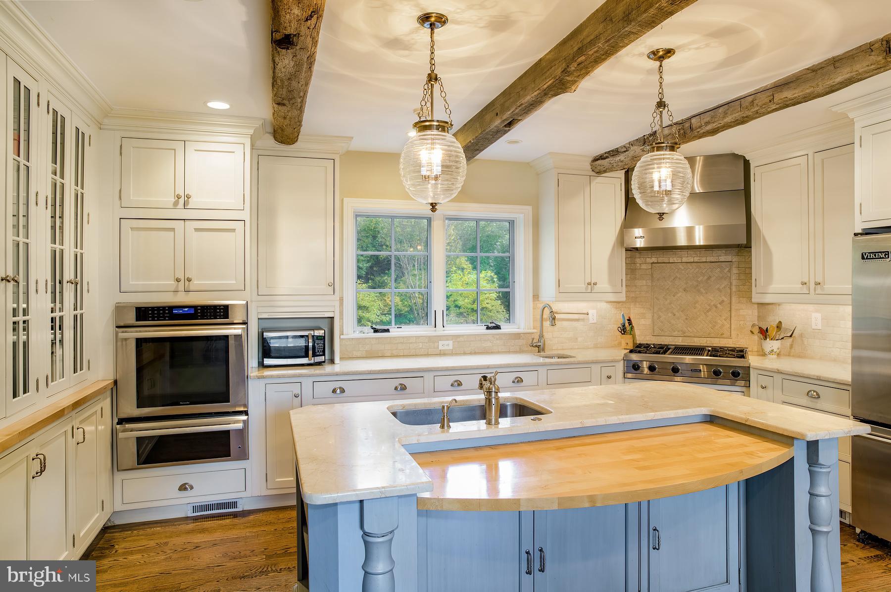412 Righters Mill Road Narberth, PA 19072 - Photo 18 of 53 a kitchen with stainless steel appliances kitchen island granite countertop a sink stove and refrigerator