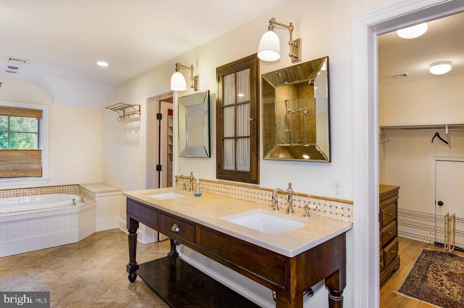 412 Righters Mill Road Narberth, PA 19072 - Photo 24 of 53 a bathroom with a sink double vanity granite tub shower and a mirror