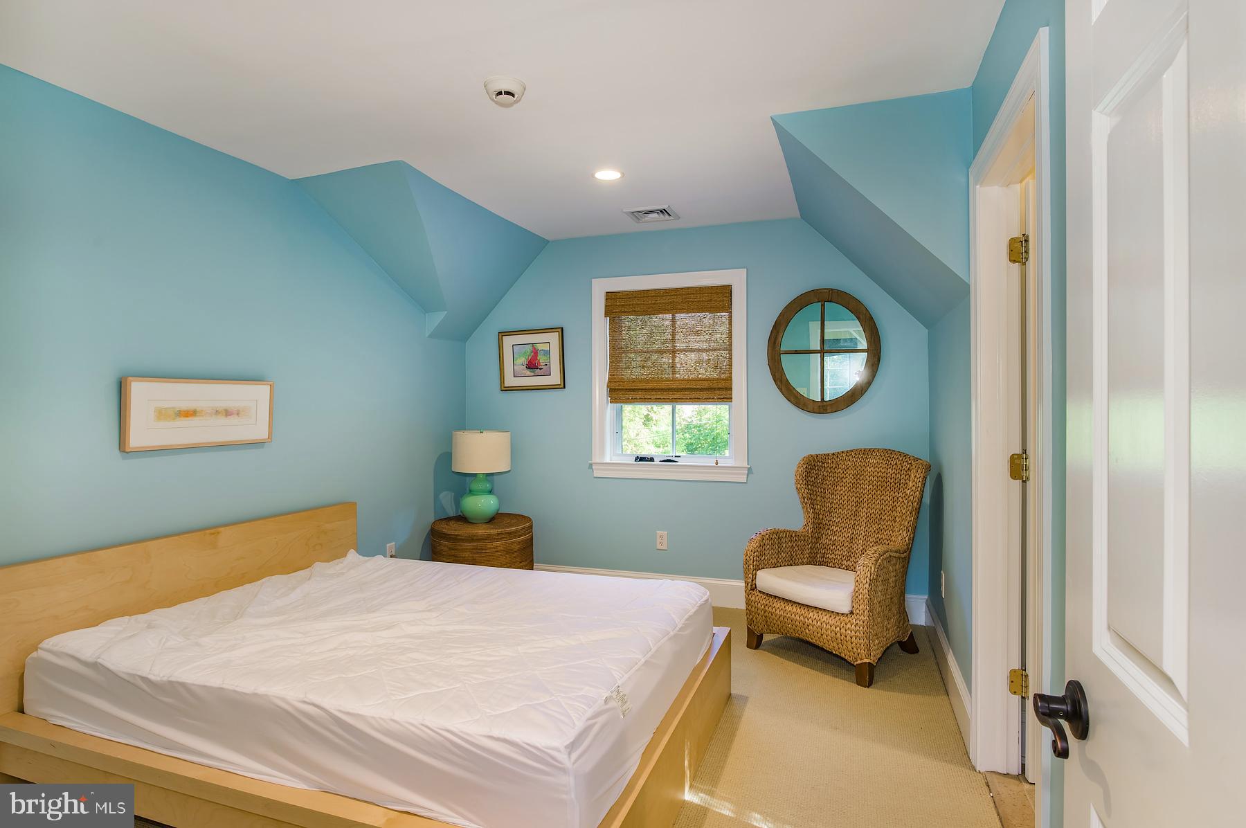 412 Righters Mill Road Narberth, PA 19072 - Photo 36 of 53 a bedroom with a bed and a chair with paintings on wall