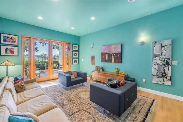 a living room with furniture and a book shelf