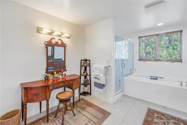 a spacious bathroom with a granite countertop tub sink and mirror