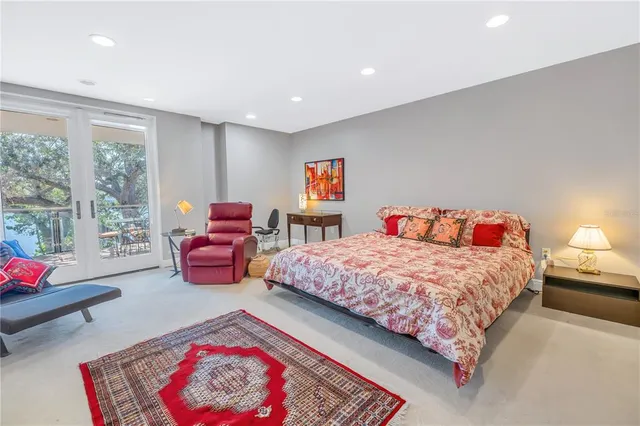 a dining room with furniture and a floor to ceiling window