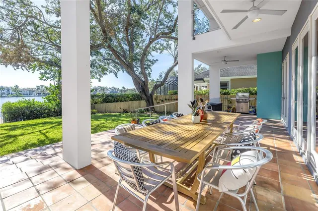 a view of a porch with chairs and backyard