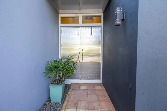 a view of a house with potted plants