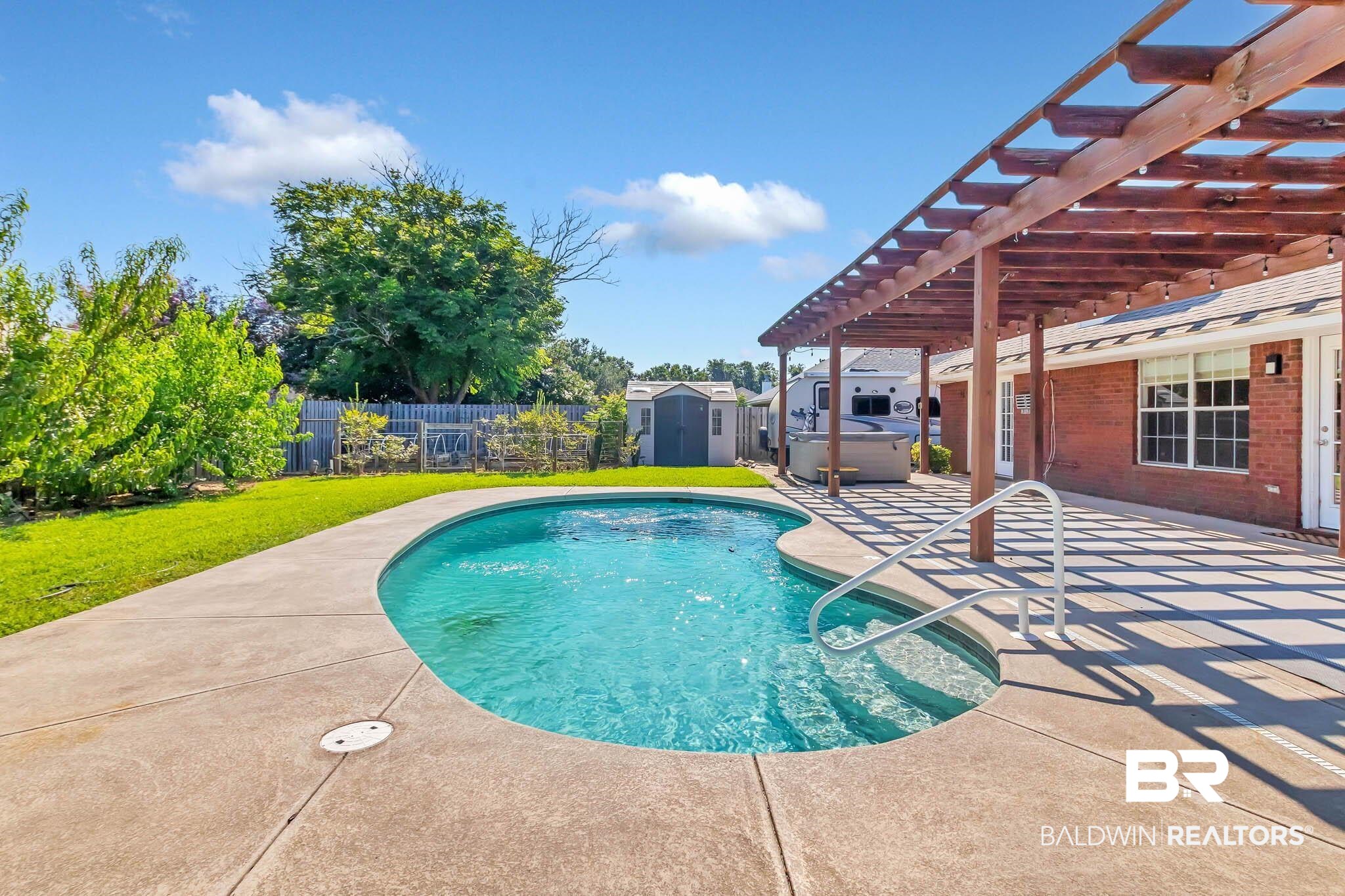 9607 Czar Court Fairhope, AL 36532 - Photo 38 of 42 View of swimming pool featuring a pergola, a shed, a patio area, a fenced backyard, and a hot tub