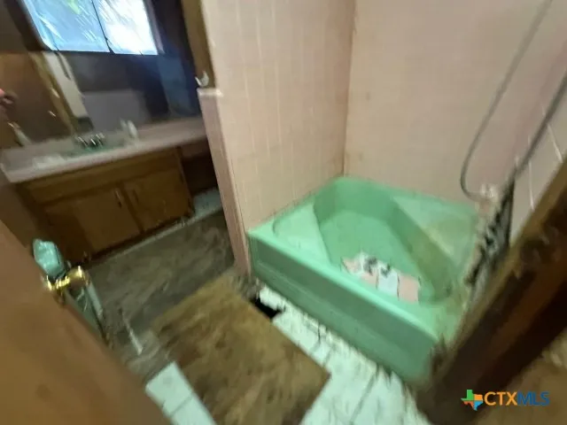a bathroom with a granite countertop toilet sink and mirror