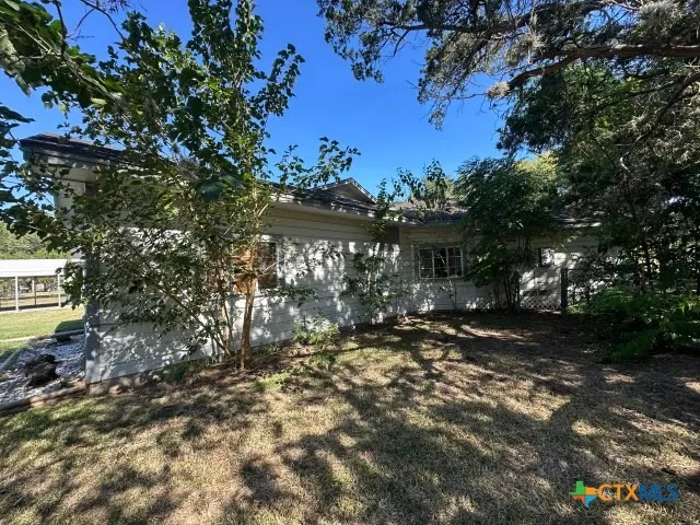 a view of a house with a tree in the background