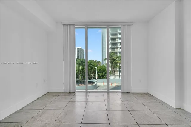 a view of a living room with a floor to ceiling window and an outdoor view