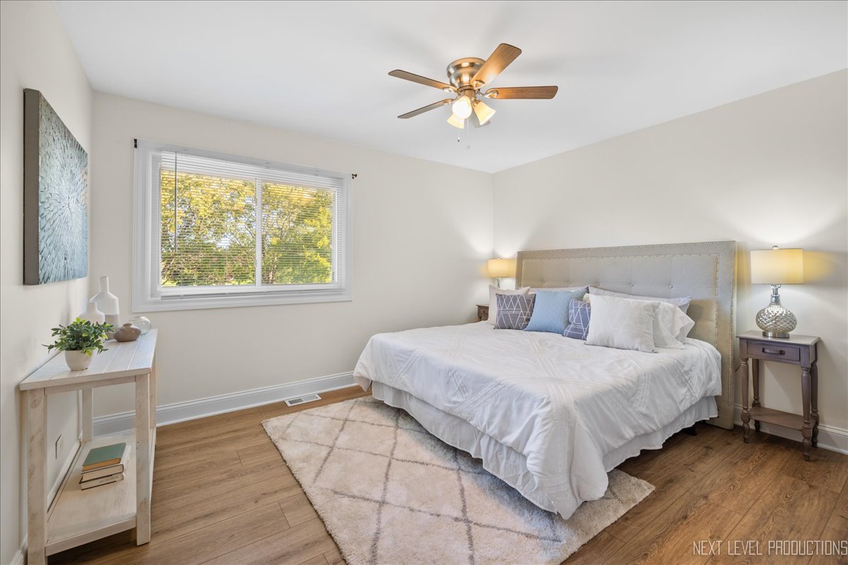 5628 Crestwood Road Matteson, IL 60443 - Photo 12 of 29 a bedroom with a bed and a chandelier