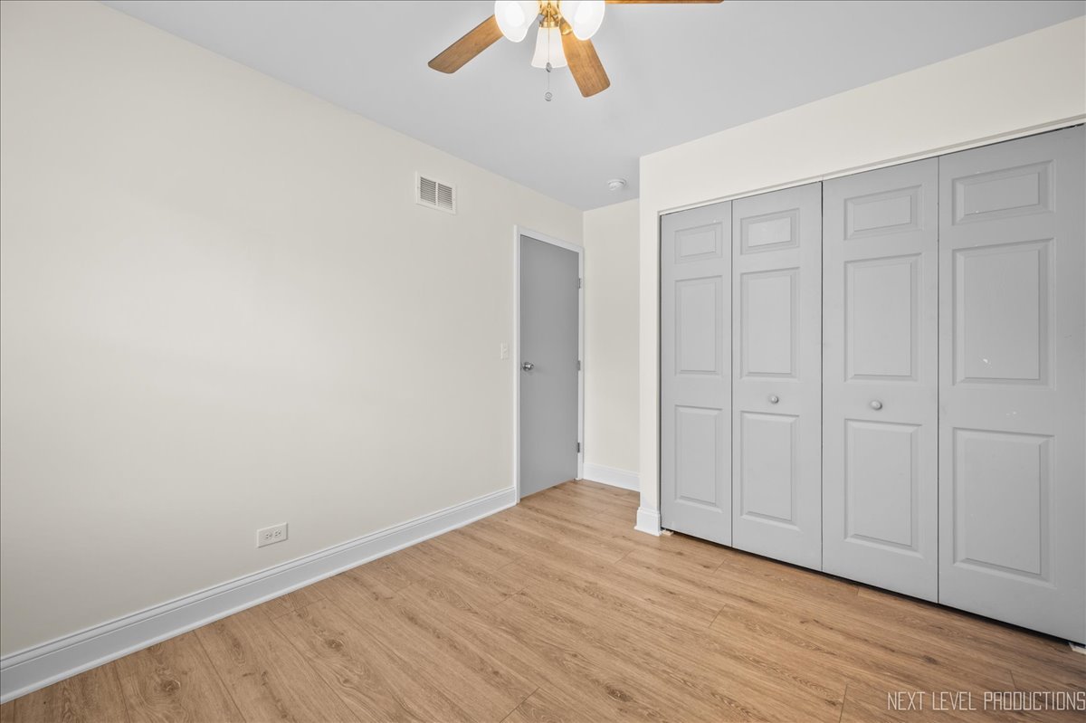 5628 Crestwood Road Matteson, IL 60443 - Photo 18 of 29 a view of an empty room with wooden floor