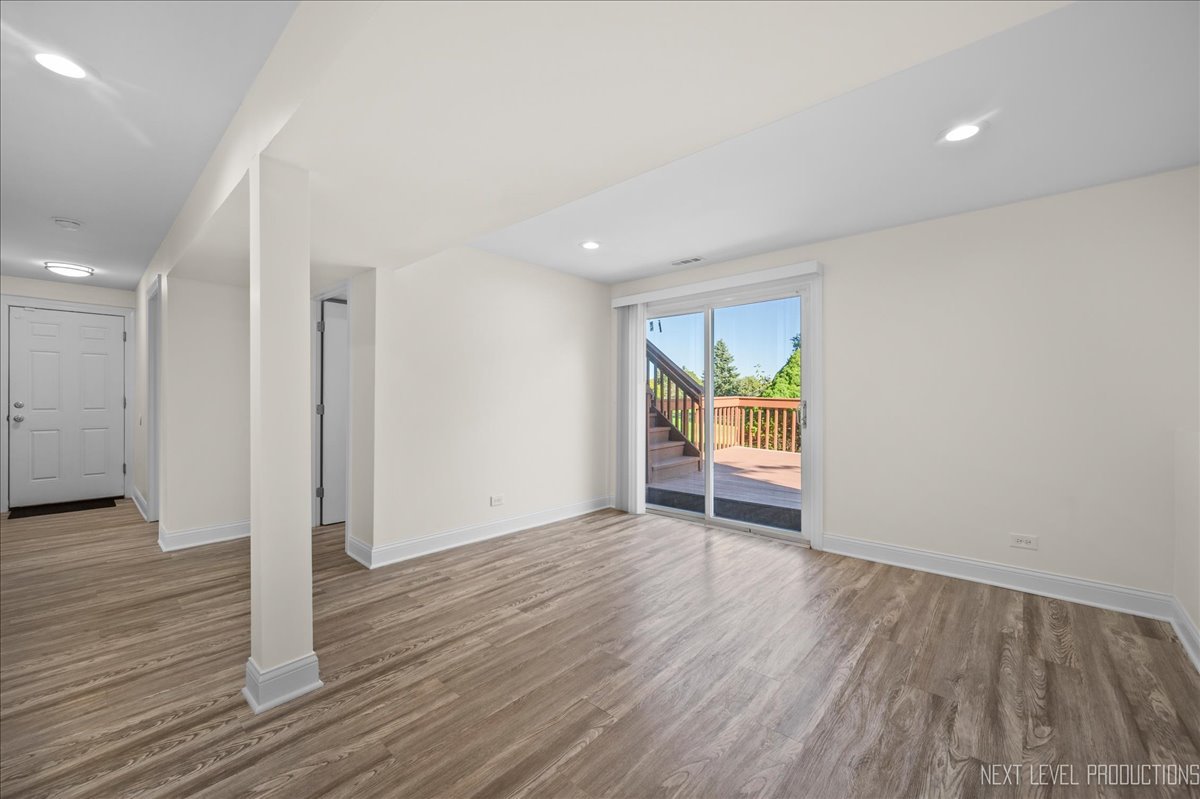 5628 Crestwood Road Matteson, IL 60443 - Photo 19 of 29 an empty room with wooden floor and window