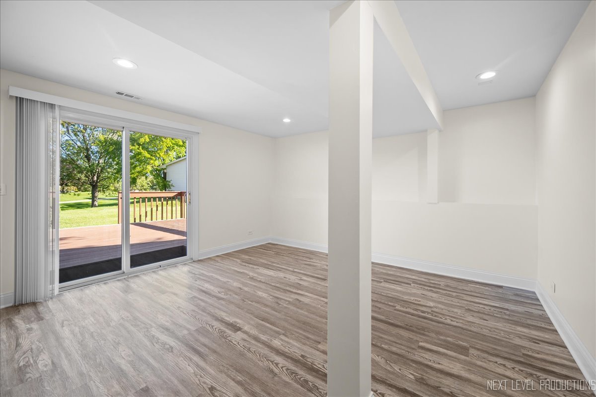 5628 Crestwood Road Matteson, IL 60443 - Photo 21 of 29 a view of an empty room with wooden floor and a window