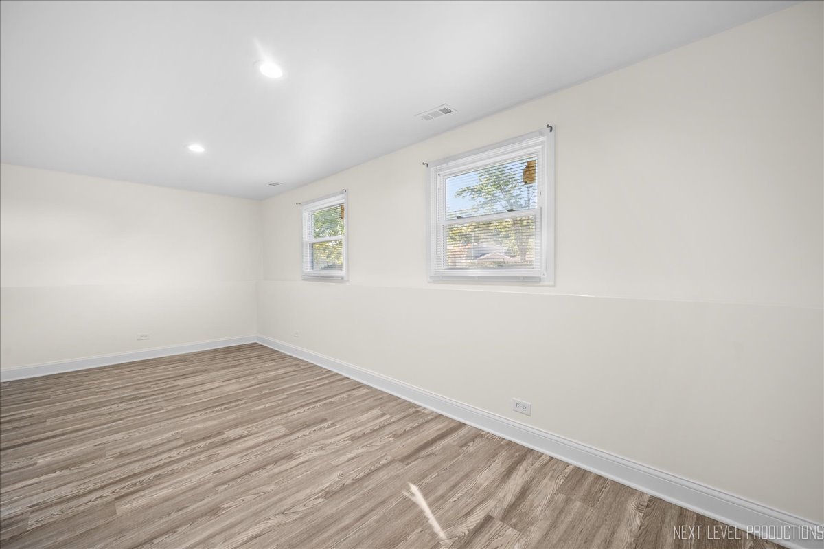 5628 Crestwood Road Matteson, IL 60443 - Photo 22 of 29 an empty room with wooden floor and window